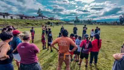 Students ready to play soccer with children in Ecuador.
