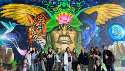 A group of students in front of a mural in Ecuador.