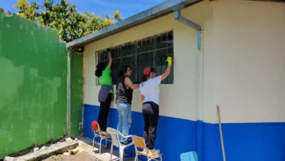 Students painting a wall.
