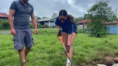 An instructor helping a student plant.