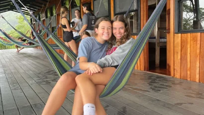 Two girls sitting in a hamock.