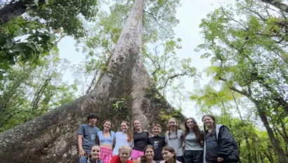 A group of students in a forest.