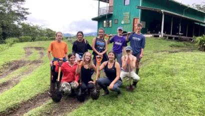 A group of students holding shovels.