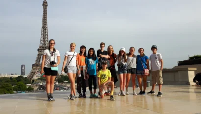 School group poses with the Eiffel tower in the background