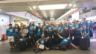 Student group stands together for a photo at Beijing airport