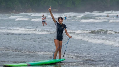 A middle school student traveler enjoying a day of adventure surfing. Global Works Teen travel programs offer a mix of learning, adventure and service.